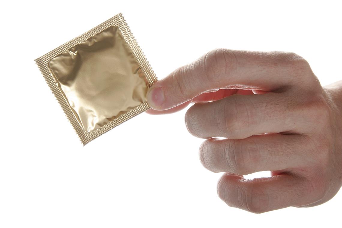 Couple applying a condom smoothly during intimate moments for safe and confident pleasure